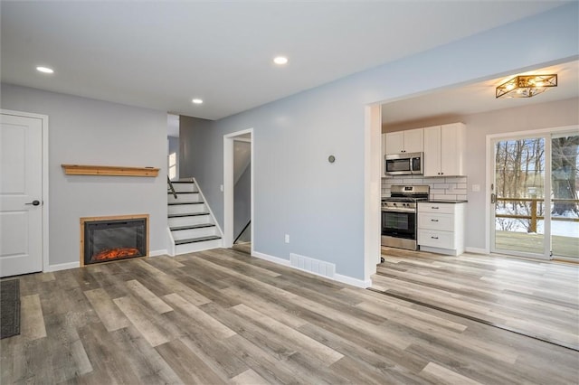 unfurnished living room featuring light hardwood / wood-style floors