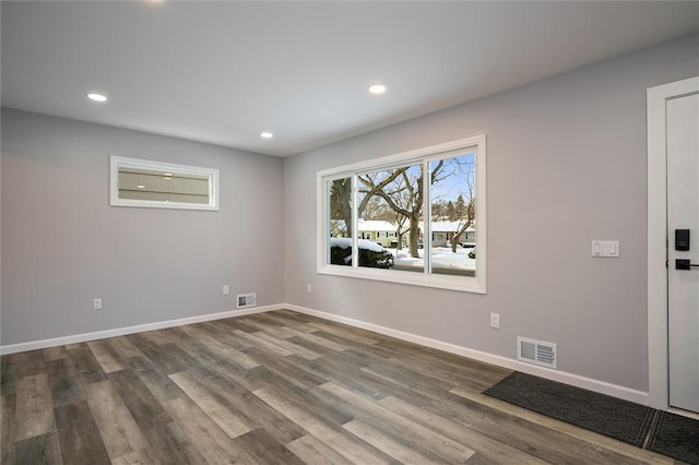 unfurnished room with hardwood / wood-style flooring