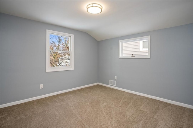 bonus room with lofted ceiling, a healthy amount of sunlight, and carpet flooring