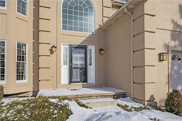 view of snow covered property entrance