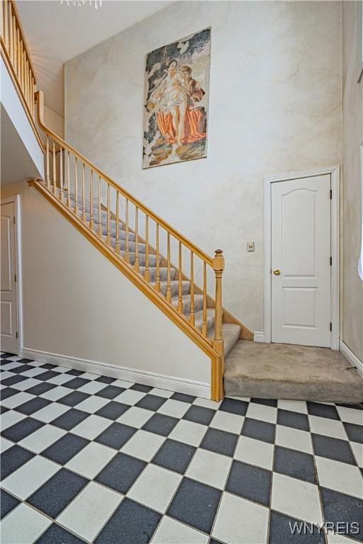 stairs featuring a towering ceiling