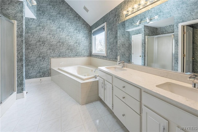 bathroom featuring tile patterned flooring, vaulted ceiling, vanity, and plus walk in shower