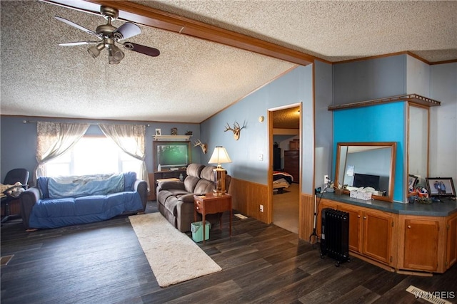 living room with radiator, dark wood-type flooring, ceiling fan, lofted ceiling with beams, and a textured ceiling