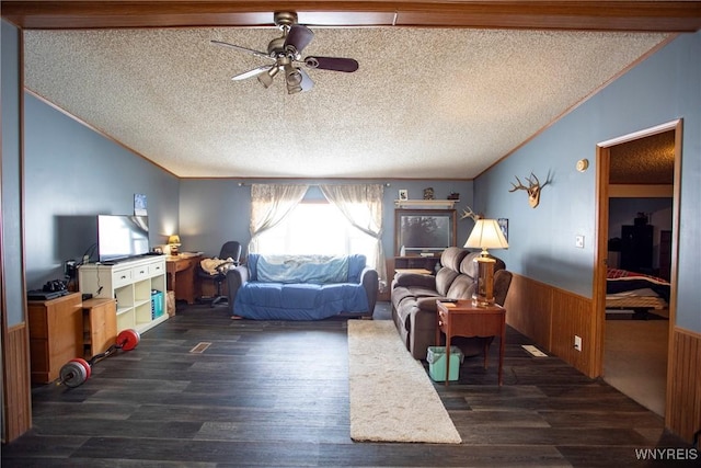 living room with crown molding, ceiling fan, a textured ceiling, and dark hardwood / wood-style flooring