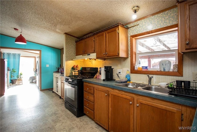 kitchen featuring black gas range, sink, lofted ceiling, and a textured ceiling