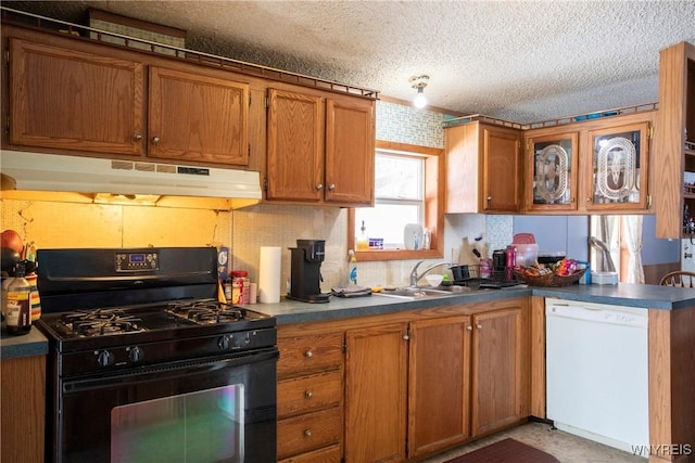 kitchen featuring dishwasher, sink, decorative backsplash, black gas stove, and a textured ceiling