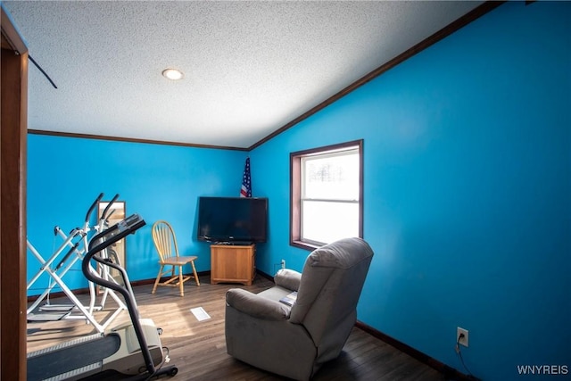 interior space featuring crown molding, hardwood / wood-style flooring, vaulted ceiling, and a textured ceiling