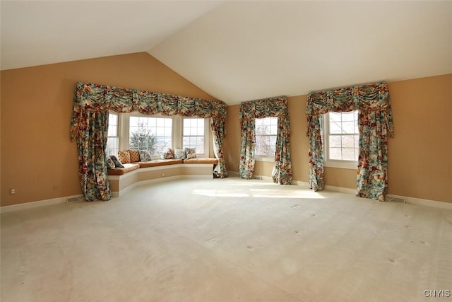 unfurnished living room featuring lofted ceiling and light colored carpet