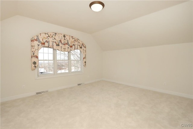 bonus room with lofted ceiling and carpet flooring