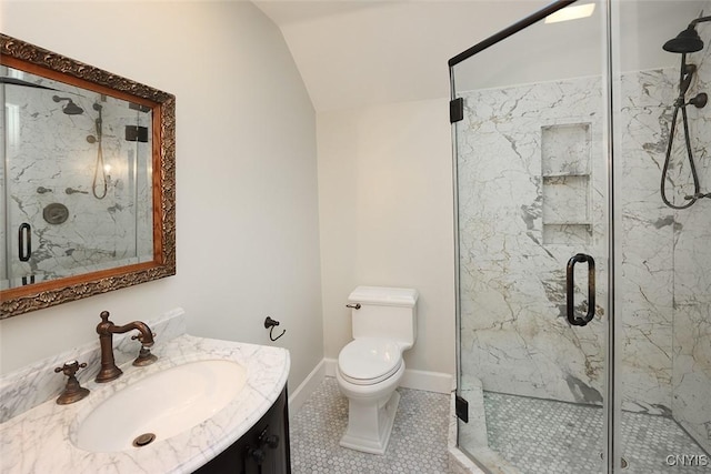 bathroom with vaulted ceiling, vanity, an enclosed shower, toilet, and tile patterned floors