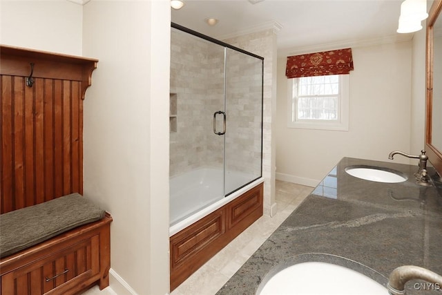 bathroom featuring ornamental molding, shower / bath combination with glass door, and vanity