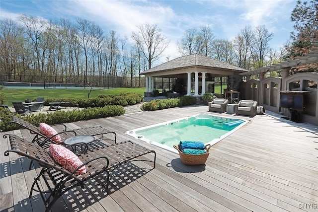 view of swimming pool with a wooden deck, a gazebo, and an outdoor living space