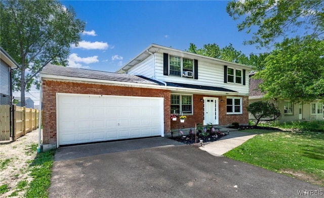 view of front of house with a garage and a front yard