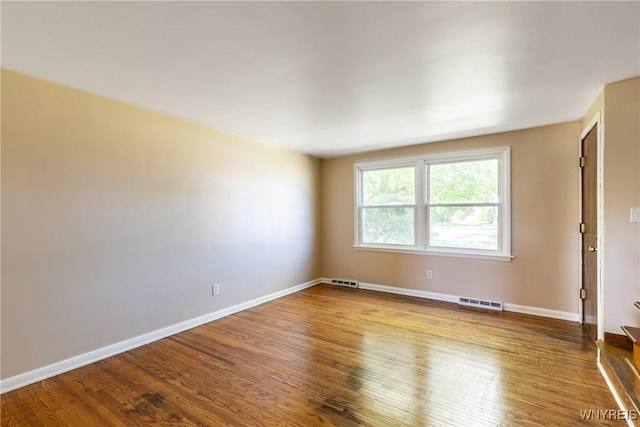 spare room with hardwood / wood-style floors