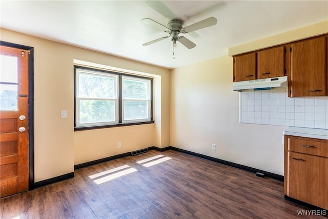 kitchen with decorative backsplash, dark wood-type flooring, and ceiling fan