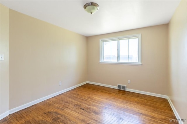 empty room featuring hardwood / wood-style floors