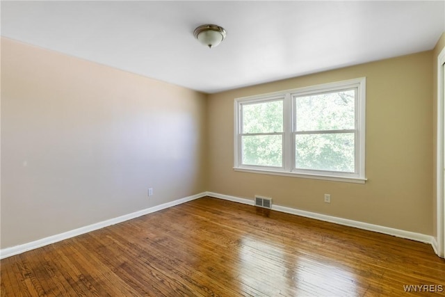 empty room with hardwood / wood-style floors