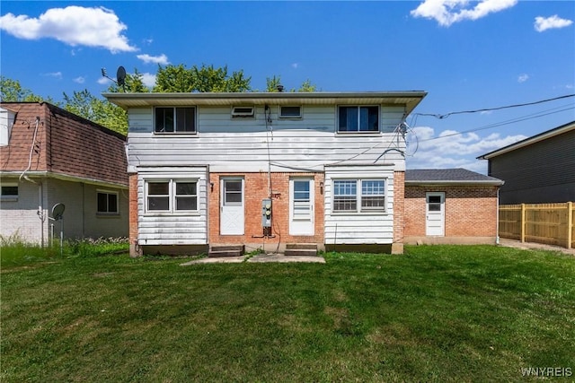 back of house with a lawn