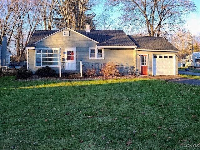 single story home featuring a garage and a front yard