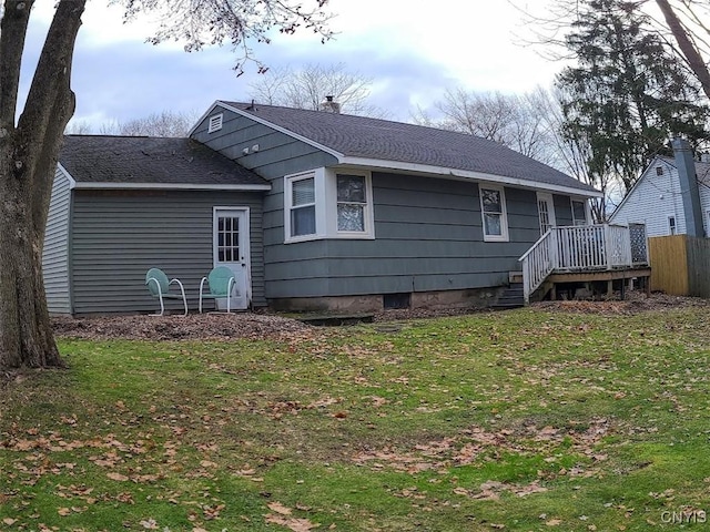 rear view of house featuring a yard