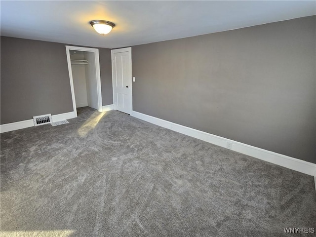 unfurnished bedroom with dark colored carpet