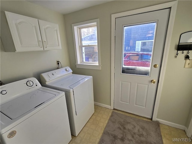 laundry area with washer and clothes dryer and cabinets