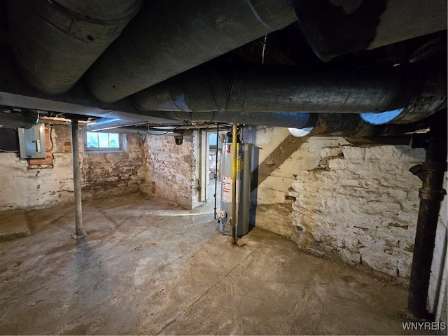 basement featuring gas water heater and electric panel