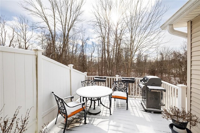 snow covered deck featuring grilling area