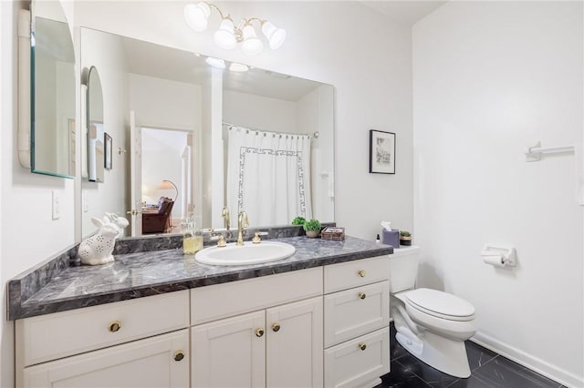 bathroom featuring vanity, tile patterned floors, and toilet