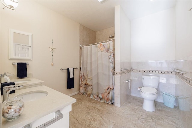 bathroom featuring tile walls, vanity, toilet, and walk in shower