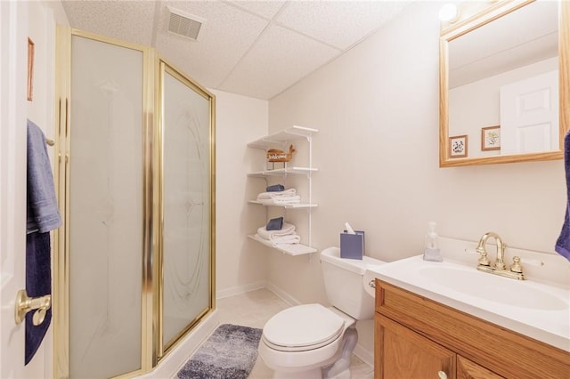 bathroom featuring vanity, a paneled ceiling, toilet, and walk in shower