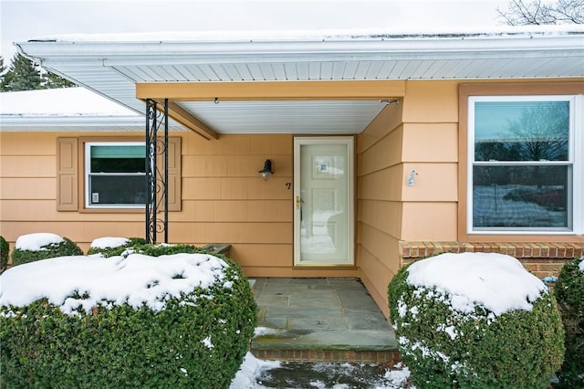 view of snow covered property entrance