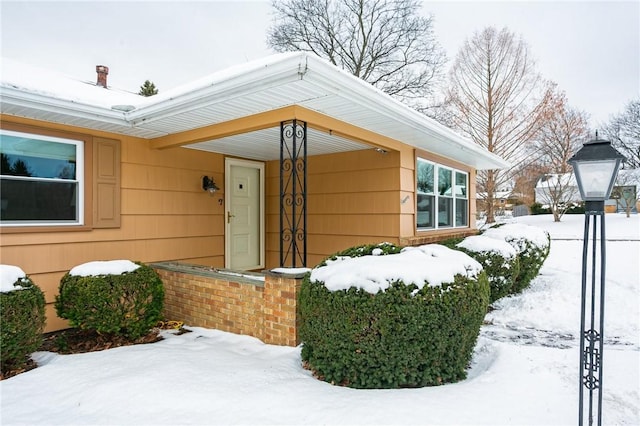 view of snow covered property entrance