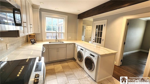 washroom with washer and dryer and sink