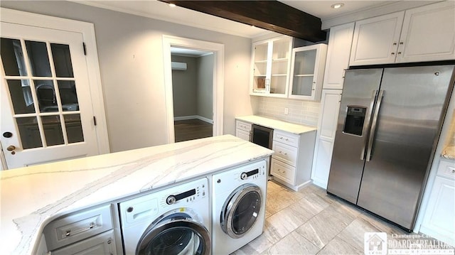 clothes washing area featuring crown molding and independent washer and dryer