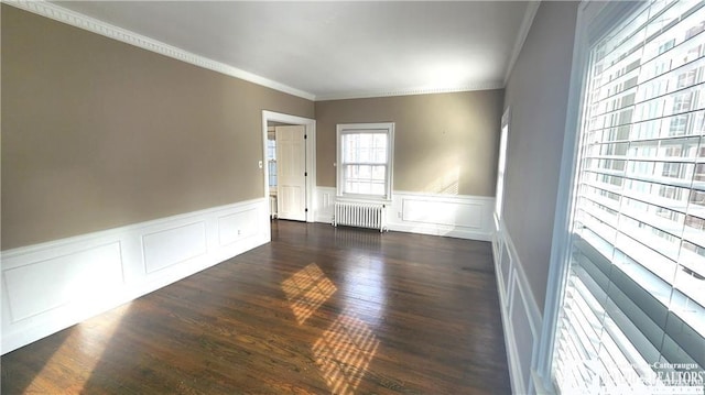 unfurnished room featuring crown molding, radiator, and dark hardwood / wood-style floors