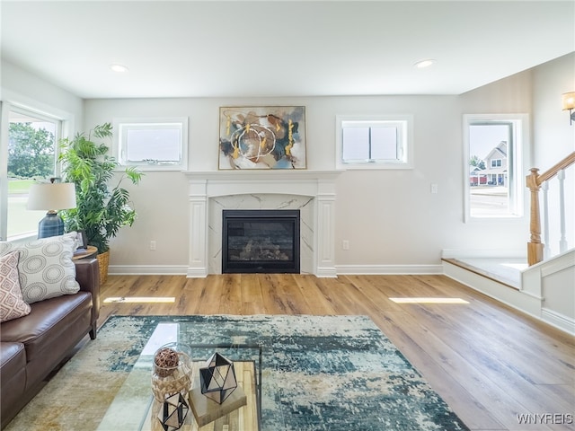 living room with a fireplace and light hardwood / wood-style floors