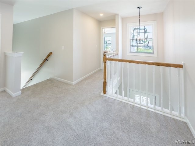 spare room featuring light carpet