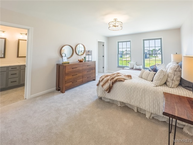 carpeted bedroom featuring ensuite bath