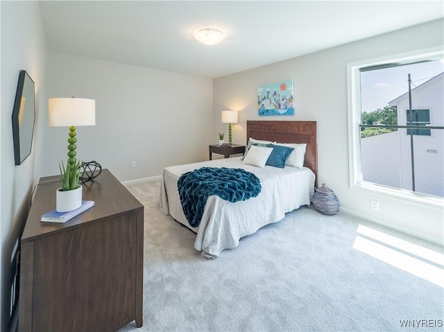 bedroom featuring light carpet