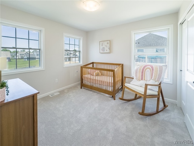 bedroom featuring light carpet and a closet