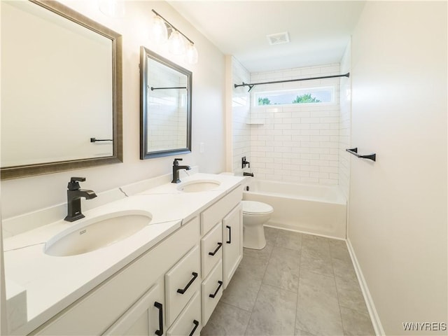 full bathroom featuring tile patterned floors, vanity, toilet, and tiled shower / bath combo