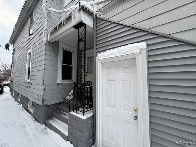 view of snow covered property entrance