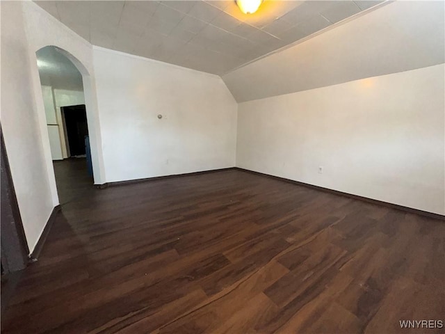 bonus room featuring lofted ceiling and dark hardwood / wood-style flooring