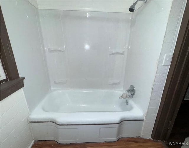 bathroom featuring bathtub / shower combination and hardwood / wood-style floors