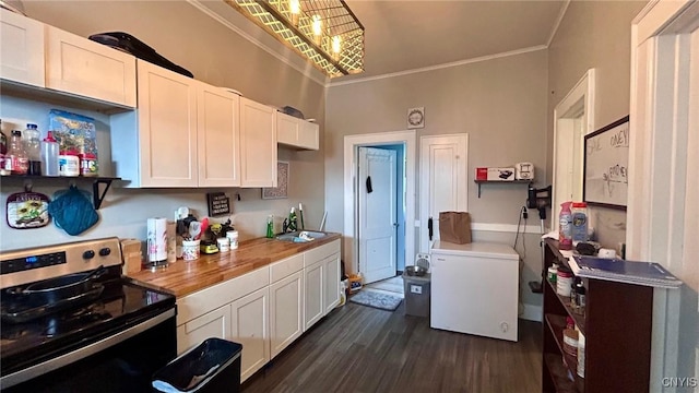 kitchen featuring butcher block countertops, dark wood-style flooring, white cabinets, fridge, and stainless steel electric range