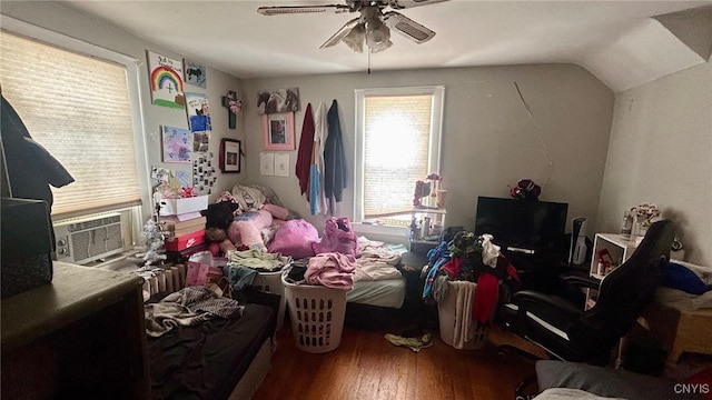 bedroom with lofted ceiling, cooling unit, dark wood finished floors, and ceiling fan