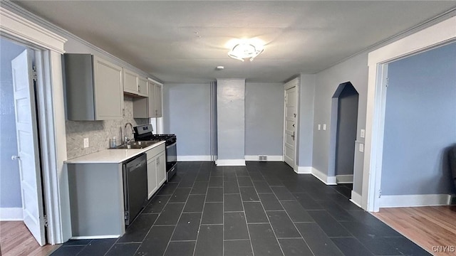 kitchen with stainless steel range with gas cooktop, sink, dishwashing machine, and decorative backsplash