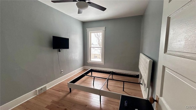 unfurnished bedroom featuring hardwood / wood-style flooring and ceiling fan