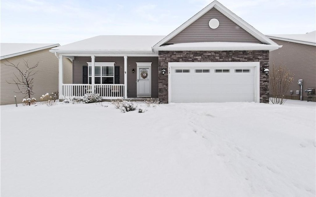 single story home with a garage and covered porch